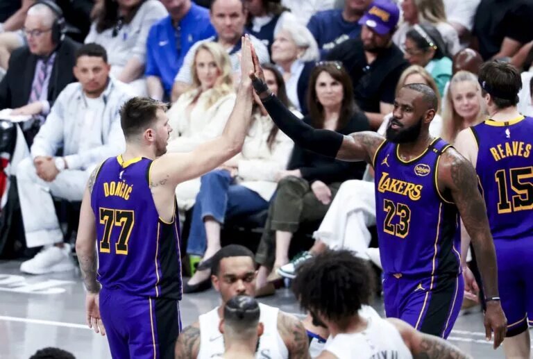 Apr 9, 2025; Dallas, Texas, USA; Los Angeles Lakers guard Luka Doncic (77) celebrates with Los Angeles Lakers forward LeBron James (23) during the fourth quarter against the Dallas Mavericks at American Airlines Center. Mandatory Credit: Kevin Jairaj-Imagn Images