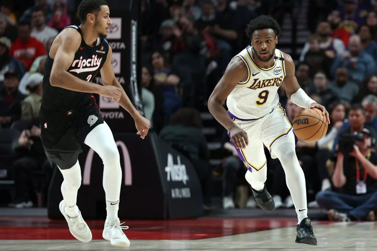 Apr 13, 2025; Portland, Oregon, USA; Los Angeles Lakers guard Bronny James (9) brings the ball up the court past Portland Trail Blazers forward Kris Murray (24) in the second half at Moda Center. Mandatory Credit: Jaime Valdez-Imagn Images