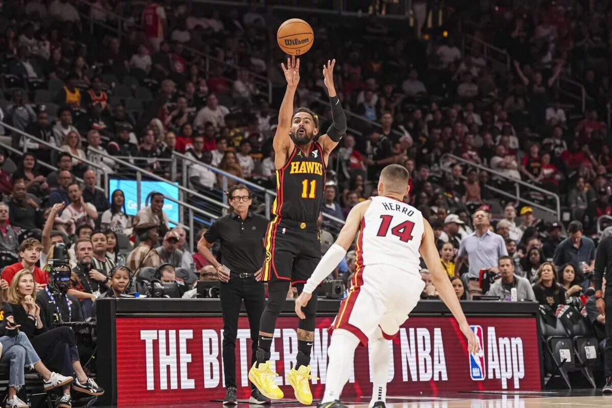 Apr 18, 2025; Atlanta, Georgia, USA; Atlanta Hawks guard Trae Young (11) shoots over Miami Heat guard Tyler Herro (14) during the first half at State Farm Arena. Mandatory Credit: Dale Zanine-Imagn Images
