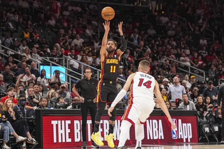 Apr 18, 2025; Atlanta, Georgia, USA; Atlanta Hawks guard Trae Young (11) shoots over Miami Heat guard Tyler Herro (14) during the first half at State Farm Arena. Mandatory Credit: Dale Zanine-Imagn Images