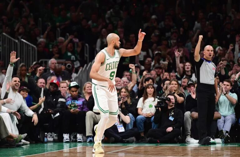 Boston Celtics guard Derrick White (9) reacts after making a three point basket during the first half against the Orlando Magic at TD Garden.