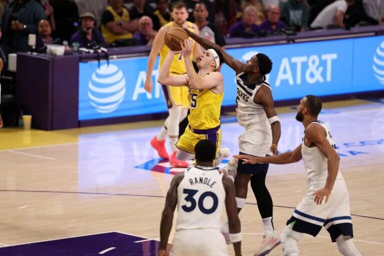 Apr 22, 2025; Los Angeles, California, USA; Los Angeles Lakers guard Austin Reaves (15) is fouled by Minnesota Timberwolves guard Anthony Edwards (5) during the third quarter of game two of first round for the 2024 NBA Playoffs at Crypto.com Arena. Mandatory Credit: Kiyoshi Mio-Imagn Images