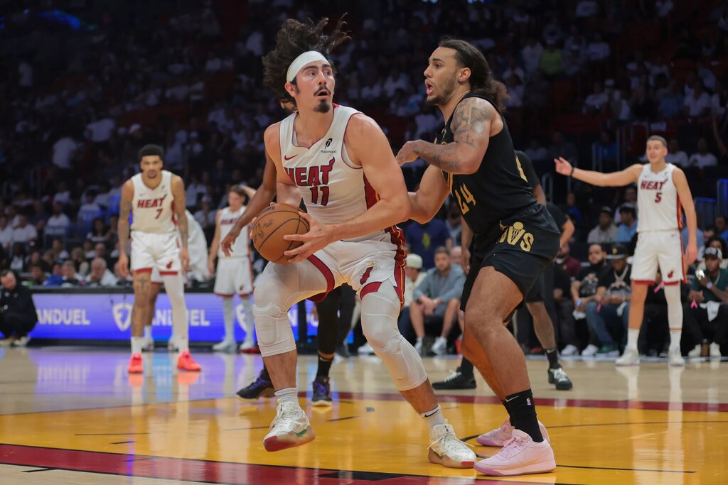 Apr 28, 2025; Miami, Florida, USA; Miami Heat guard Jaime Jaquez Jr. (11) drives to the basket against Cleveland Cavaliers forward Jaylon Tyson (24) in the fourth quarter during game four for the first round of the 2025 NBA Playoffs at Kaseya Center. Mandatory Credit: Sam Navarro-Imagn Images