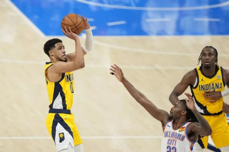 Jun 5, 2025; Oklahoma City, Oklahoma, USA; Indiana Pacers guard Tyrese Haliburton (0) shoots the ball against Oklahoma City Thunder guard Cason Wallace (22) during the fourth quarter in game one of the 2025 NBA Finals at Paycom Center. Mandatory Credit: Kyle Terada-Imagn Images