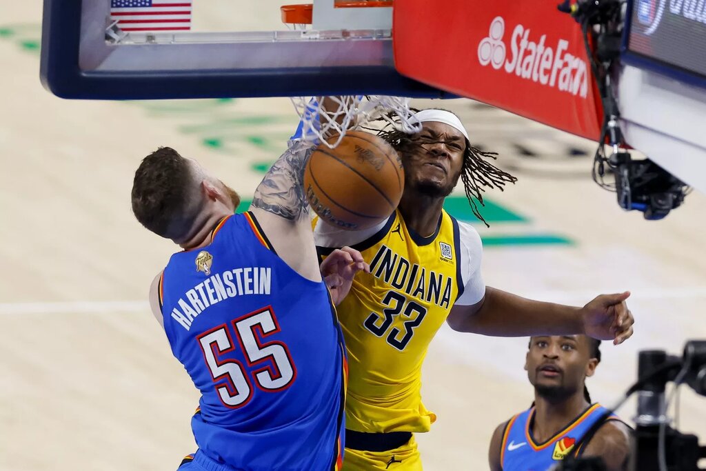 Jun 8, 2025; Oklahoma City, Oklahoma, USA; Oklahoma City Thunder center Isaiah Hartenstein (55) and Indiana Pacers center Myles Turner (33) battle for the ball during the fourth quarter of game two of the 2025 NBA Finals at Paycom Center. Mandatory Credit: Alonzo Adams-Imagn Images