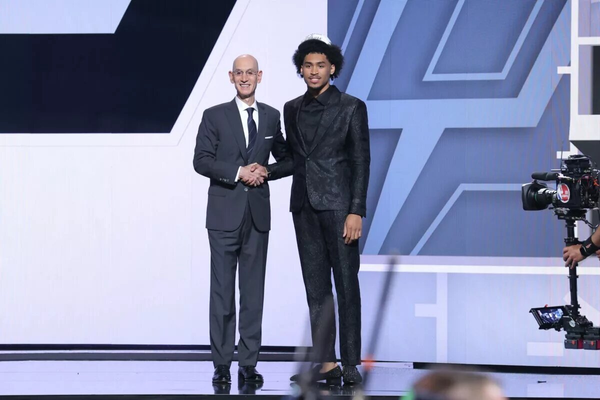 Dylan Harper stands with NBA commissioner Adam Silver after being selected as the second pick by the San Antonio Spurs in the first round of the 2025 NBA Draft at Barclays Center.