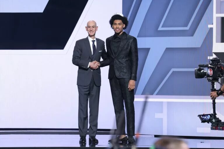 Dylan Harper stands with NBA commissioner Adam Silver after being selected as the second pick by the San Antonio Spurs in the first round of the 2025 NBA Draft at Barclays Center.