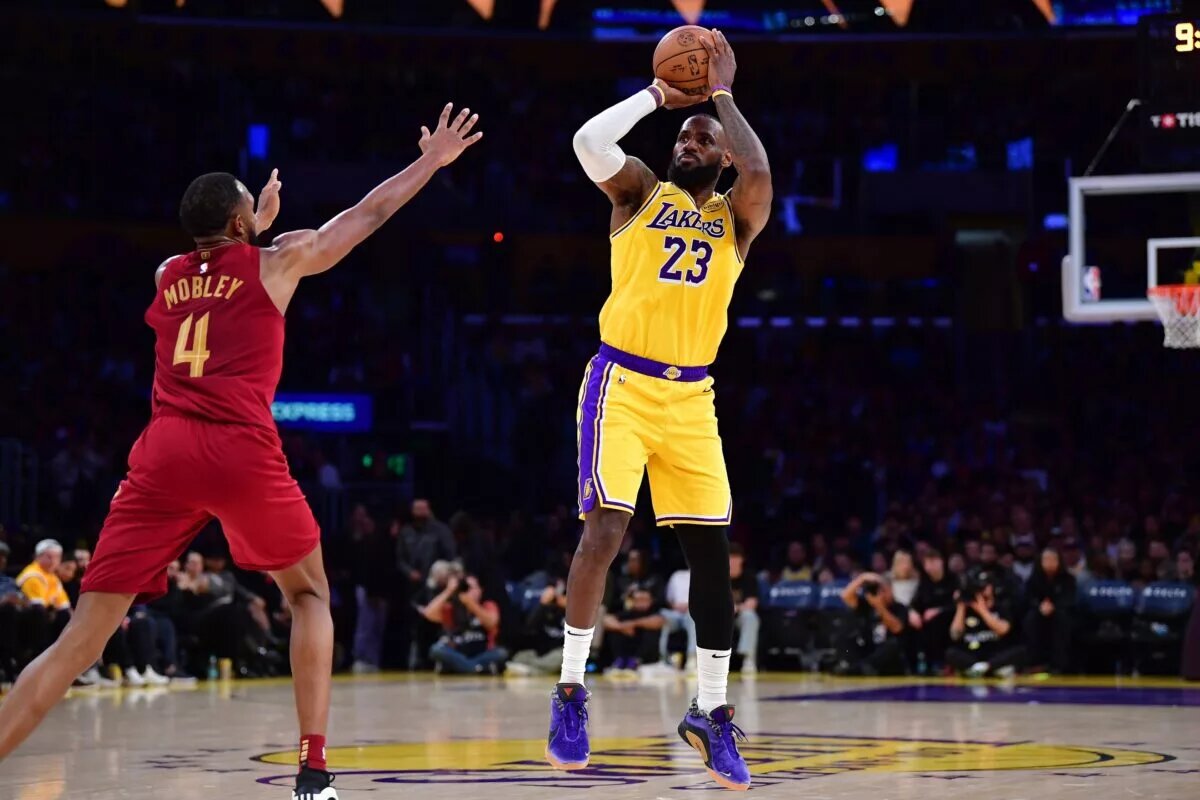 Dec 31, 2024; Los Angeles, California, USA; Los Angeles Lakers forward LeBron James (23) shoots against Cleveland Cavaliers Cleveland Cavaliers forward Evan Mobley (4) during the first half at Crypto.com Arena. Mandatory Credit: Gary A. Vasquez-Imagn Images