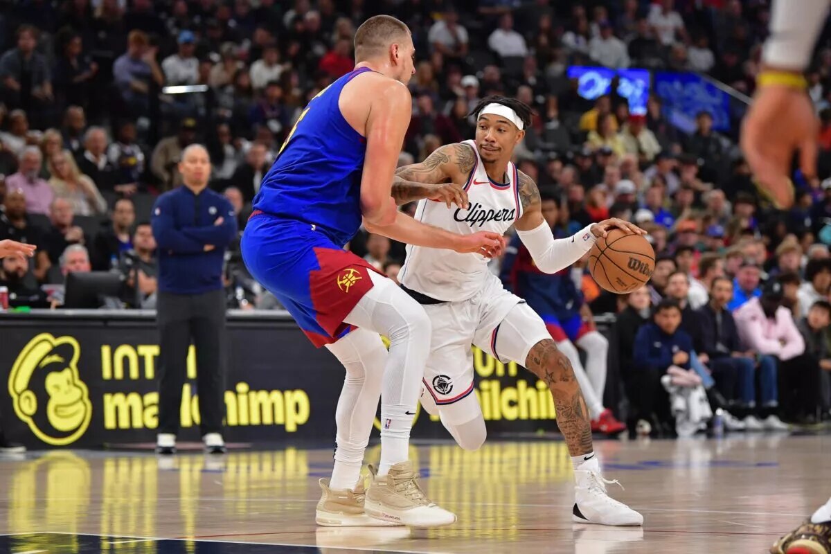 Los Angeles Clippers wing Jordan Miller attempts to score against Denver Nuggets center Nikola Jokic
