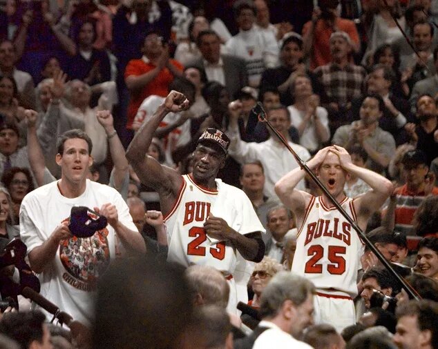 Chicago Bulls players Judd Buechler, left, Michael Jordan, middle, and Steve Kerr celebrate after winning the NBA championship after defeating the Utah Jazz in the 1997 NBA Finals at the United Center. 