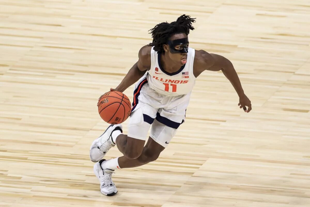 Illinois Fighting Illini guard Ayo Dosunmu (11) controls the ball in the game against the Rutgers Scarlet Knights in the first half at Lucas Oil Stadium.