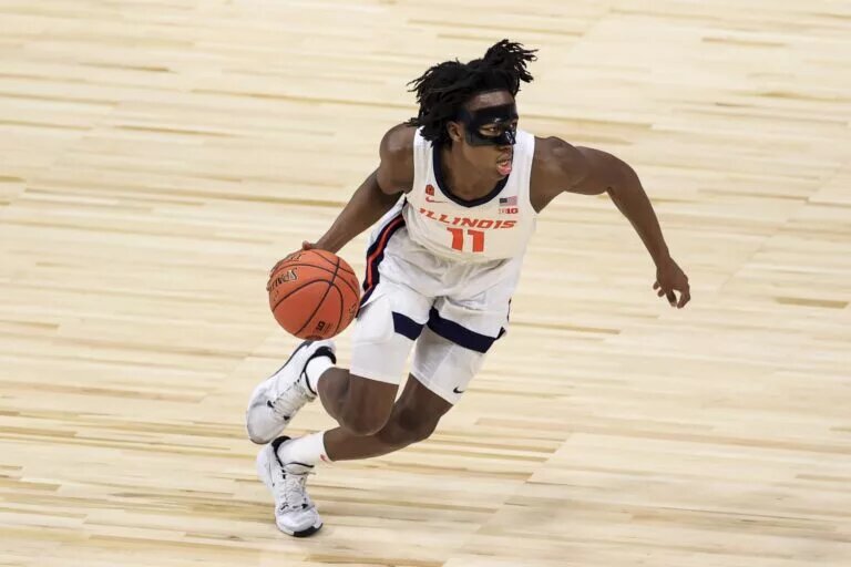 Illinois Fighting Illini guard Ayo Dosunmu (11) controls the ball in the game against the Rutgers Scarlet Knights in the first half at Lucas Oil Stadium.