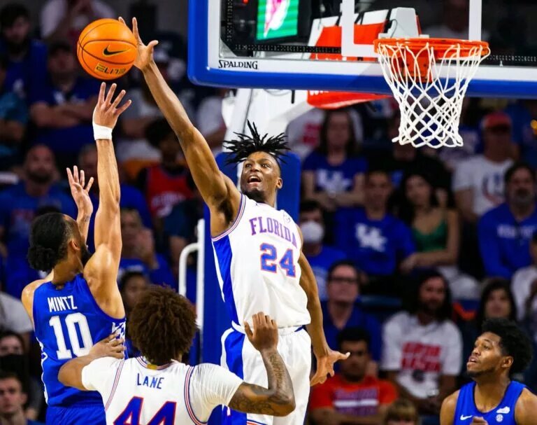 Florida Gators guard Phlandrous Fleming Jr. (24) blocks a shot by Kentucky Wildcats guard Davion Mintz (10). The Kentucky Wildcats won 71-63 over the Florida Gators Saturday afternoon, March 5, 2022 at the Stephen C. O'Connell Center in Gainesville, FL. [Doug Engle/Ocala Star Banner]2022 Gai Uf Kentucky Basketball