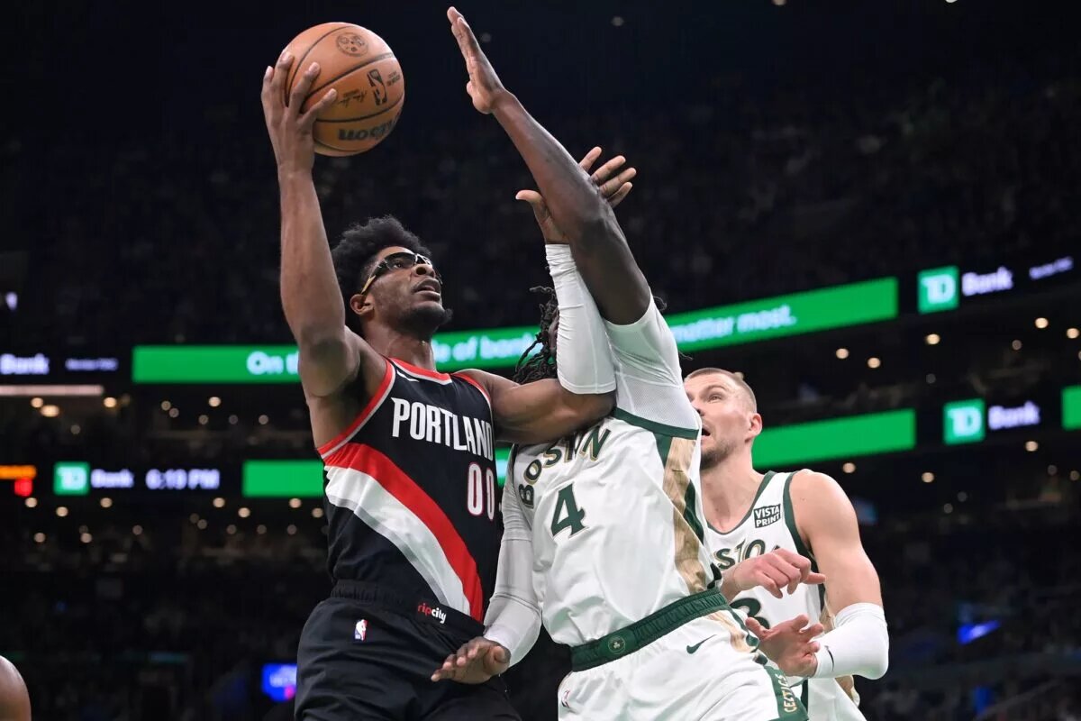 Portland Trail Blazers guard Scoot Henderson (00) shoots the ball against Boston Celtics guard Jrue Holiday (4) during the first half at TD Garden.