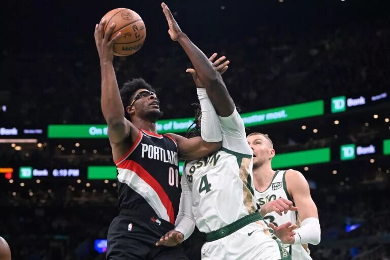 Portland Trail Blazers guard Scoot Henderson (00) shoots the ball against Boston Celtics guard Jrue Holiday (4) during the first half at TD Garden.
