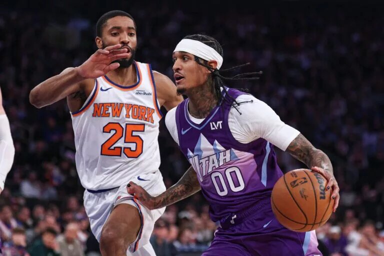 Jan 1, 2025; New York, New York, USA; Utah Jazz guard Jordan Clarkson (00) dribbles as New York Knicks forward Mikal Bridges (25) defends during the first half at Madison Square Garden. Mandatory Credit: Vincent Carchietta-Imagn Images