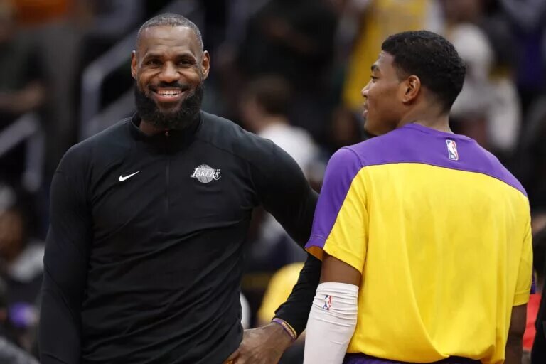 Jan 30, 2025; Washington, District of Columbia, USA; Jan 29, 2025; Washington, District of Columbia, USA; Los Angeles Lakers forward LeBron James (L) and Lakers forward Rui Hachimura (R) joke on the bench against the Washington Wizards in the third quarter at Capital One Arena. Mandatory Credit: Geoff Burke-Imagn Images