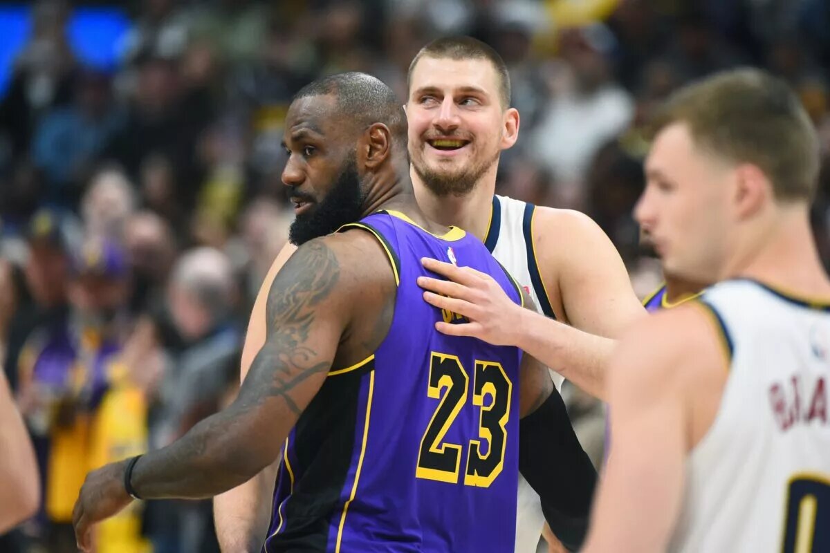 Los Angeles Lakers forward LeBron James embraces Denver Nuggets center Nikola Jokic