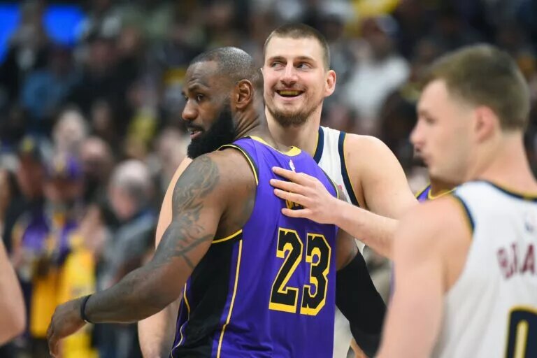 Los Angeles Lakers forward LeBron James embraces Denver Nuggets center Nikola Jokic