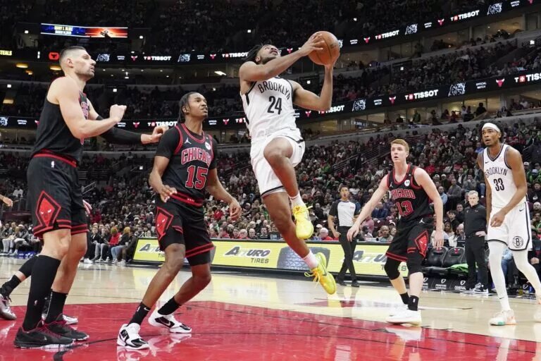 Mar 13, 2025; Chicago, Illinois, USA; Chicago Bulls forward Julian Phillips (15) defends Brooklyn Nets guard Cam Thomas (24) during the second half at United Center. Mandatory Credit: David Banks-Imagn Images