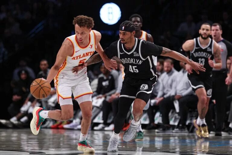 Mar 16, 2025; Brooklyn, New York, USA; Atlanta Hawks guard Dyson Daniels (5) steals the ball from Brooklyn Nets guard Keon Johnson (45) during the first quarter at Barclays Center. Mandatory Credit: Vincent Carchietta-Imagn Images
