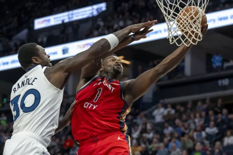 Mar 19, 2025; Minneapolis, Minnesota, USA; New Orleans Pelicans forward Zion Williamson (1) drives to the basket past Minnesota Timberwolves forward Julius Randle (30) in the second half at Target Center. Mandatory Credit: Jesse Johnson-Imagn Images