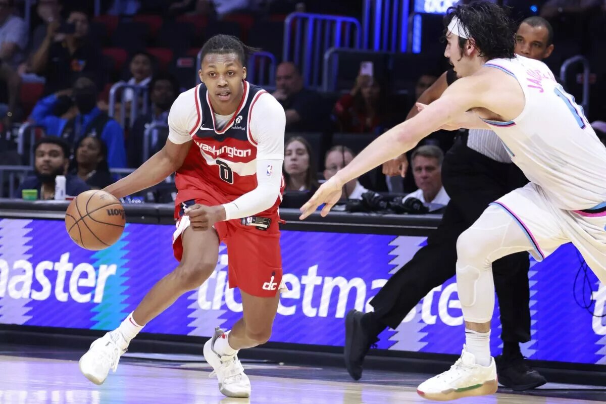 Apr 13, 2025; Miami, Florida, USA; Miami Heat guard Jaime Jaquez Jr. (11) defends Washington Wizards guard Bub Carrington (8) during the second half at Kaseya Center. Mandatory Credit: Rhona Wise-Imagn Images