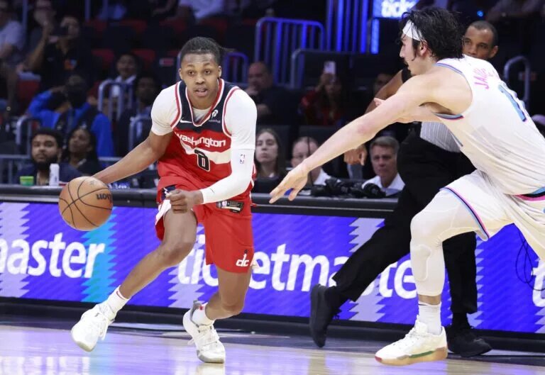Apr 13, 2025; Miami, Florida, USA; Miami Heat guard Jaime Jaquez Jr. (11) defends Washington Wizards guard Bub Carrington (8) during the second half at Kaseya Center. Mandatory Credit: Rhona Wise-Imagn Images