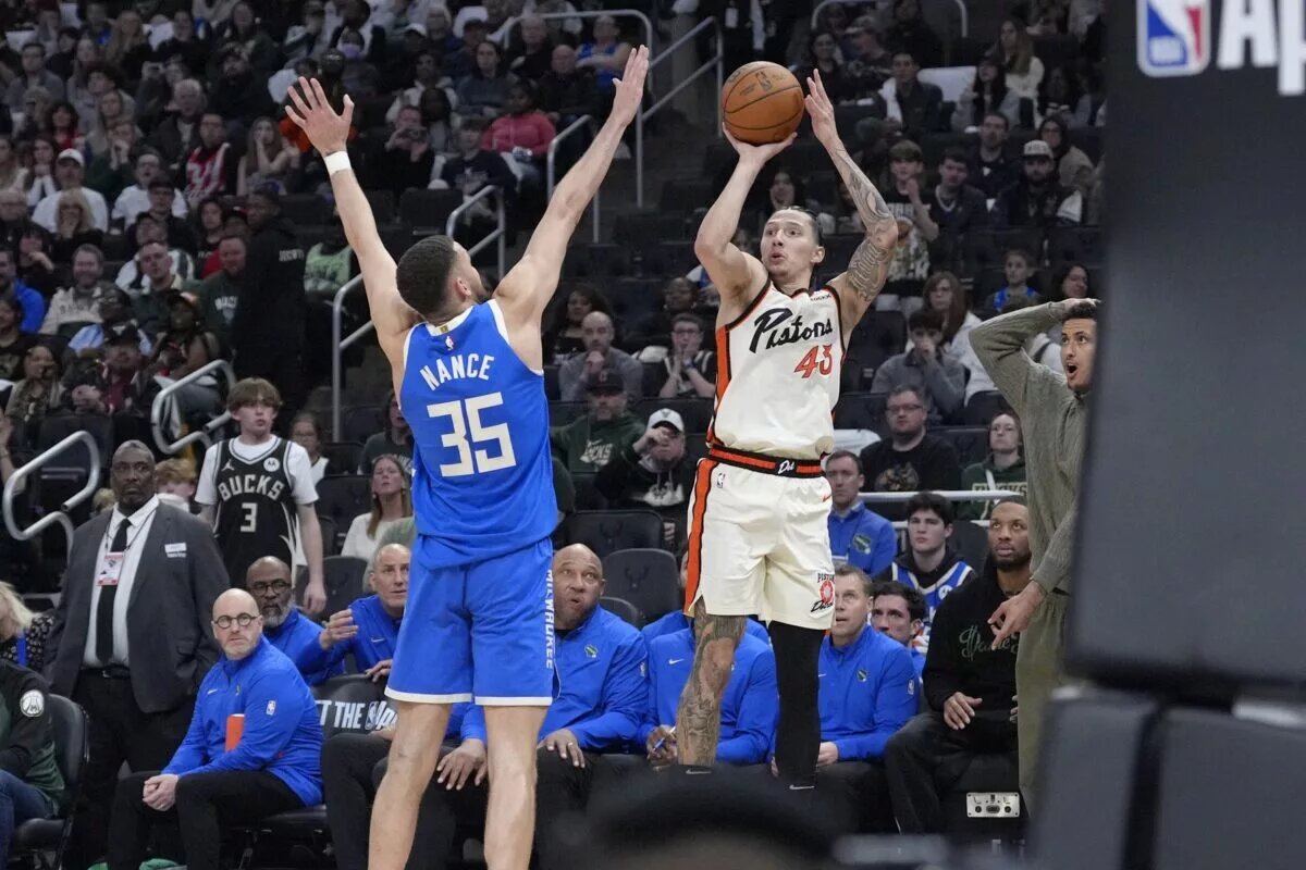 Apr 13, 2025; Milwaukee, Wisconsin, USA; Detroit Pistons forward Lindy Waters III (43) makes a last second shot against Milwaukee Bucks forward Pete Nance (35) to send the game into overtime at Fiserv Forum. Mandatory Credit: Michael McLoone-Imagn Images