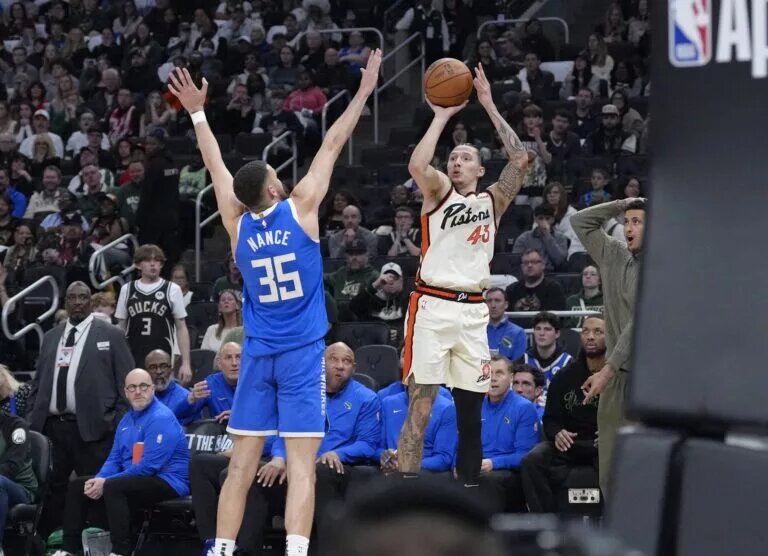 Apr 13, 2025; Milwaukee, Wisconsin, USA; Detroit Pistons forward Lindy Waters III (43) makes a last second shot against Milwaukee Bucks forward Pete Nance (35) to send the game into overtime at Fiserv Forum. Mandatory Credit: Michael McLoone-Imagn Images