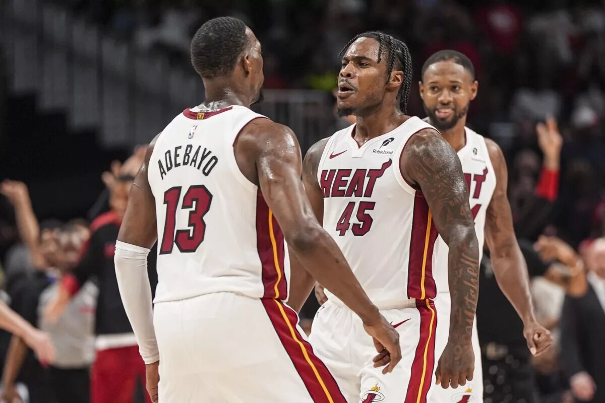 Miami Heat forward Bam Adebayo and guard Davion Mitchell chest bump