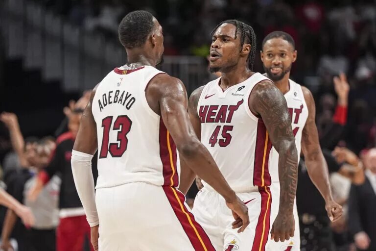 Miami Heat forward Bam Adebayo and guard Davion Mitchell chest bump