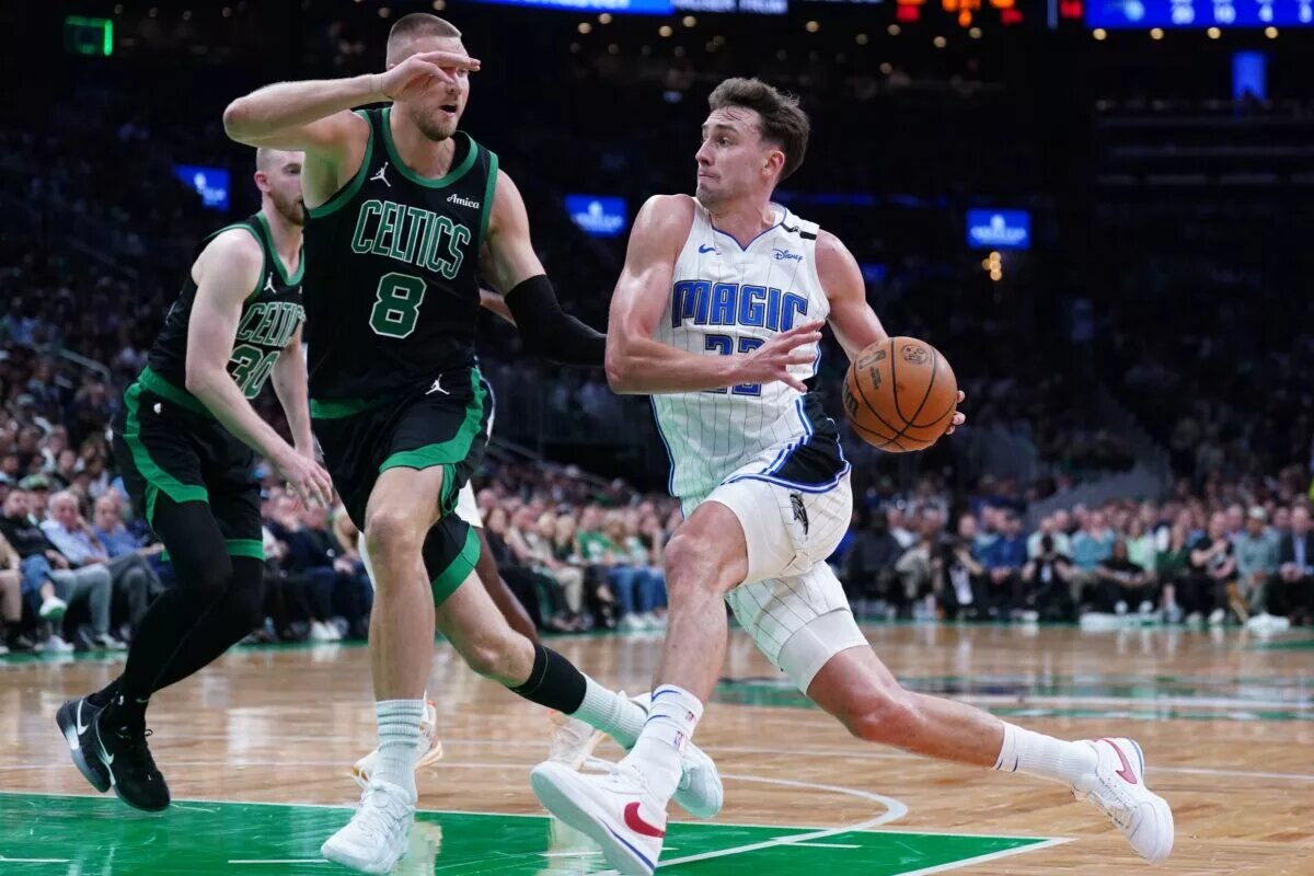 Apr 29, 2025; Boston, Massachusetts, USA; Orlando Magic forward Franz Wagner (22) drives the ball against Boston Celtics center Kristaps Porzingis (8) in the second quarter during game five of first round for the 2025 NBA Playoffs at TD Garden. Mandatory Credit: David Butler II-Imagn Images
