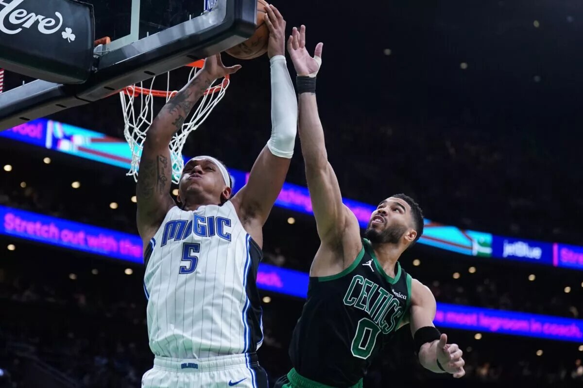 Apr 29, 2025; Boston, Massachusetts, USA; Boston Celtics forward Jayson Tatum (0) defends against Orlando Magic forward Paolo Banchero (5) in the second quarter during game five of first round for the 2025 NBA Playoffs at TD Garden. Mandatory Credit: David Butler II-Imagn Images
