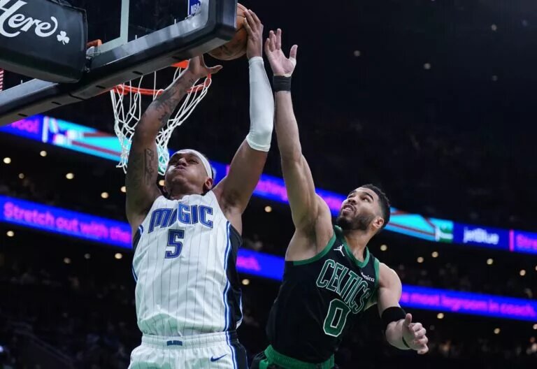 Apr 29, 2025; Boston, Massachusetts, USA; Boston Celtics forward Jayson Tatum (0) defends against Orlando Magic forward Paolo Banchero (5) in the second quarter during game five of first round for the 2025 NBA Playoffs at TD Garden. Mandatory Credit: David Butler II-Imagn Images