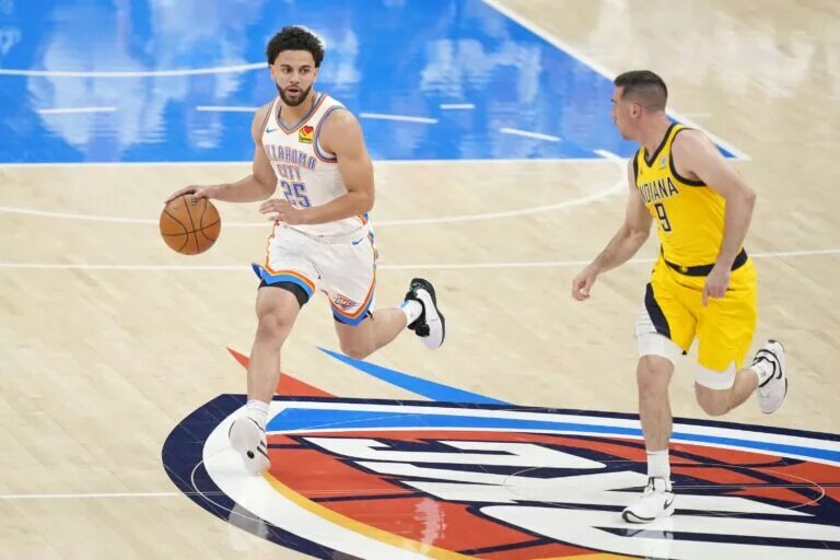 Jun 5, 2025; Oklahoma City, Oklahoma, USA; Oklahoma City Thunder guard Ajay Mitchell (25) dribbles the ball against Indiana Pacers guard T.J. McConnell (9) during the first quarter in game one of the 2025 NBA Finals at Paycom Center. Mandatory Credit: Kyle Terada-Imagn Images