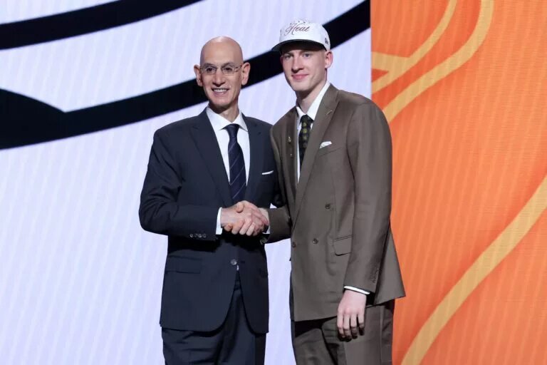 Kasparas Jakucionis stands with NBA commissioner Adam Silver after being selected as the 20th pick by the Miami Heat