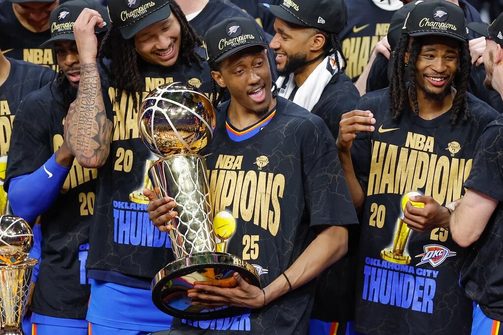 Oklahoma City Thunder forward Jalen Williams (8) holds the NBA Larry O'Brien Championship Trophy at the end of game seven of the 2025 NBA Finals after defeating the Indiana Pacers at Paycom Center. 