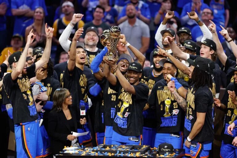 Jun 22, 2025; Oklahoma City, Oklahoma, USA; Oklahoma City Thunder forward Jalen Williams (8) holds up the Bill Russell NBA Finals MVP trophy after winner Oklahoma City Thunder guard Shai Gilgeous-Alexander hands it to him at the end of game seven of the 2025 NBA Finals against the Indiana Pacers at Paycom Center. Mandatory Credit: Alonzo Adams-Imagn Images