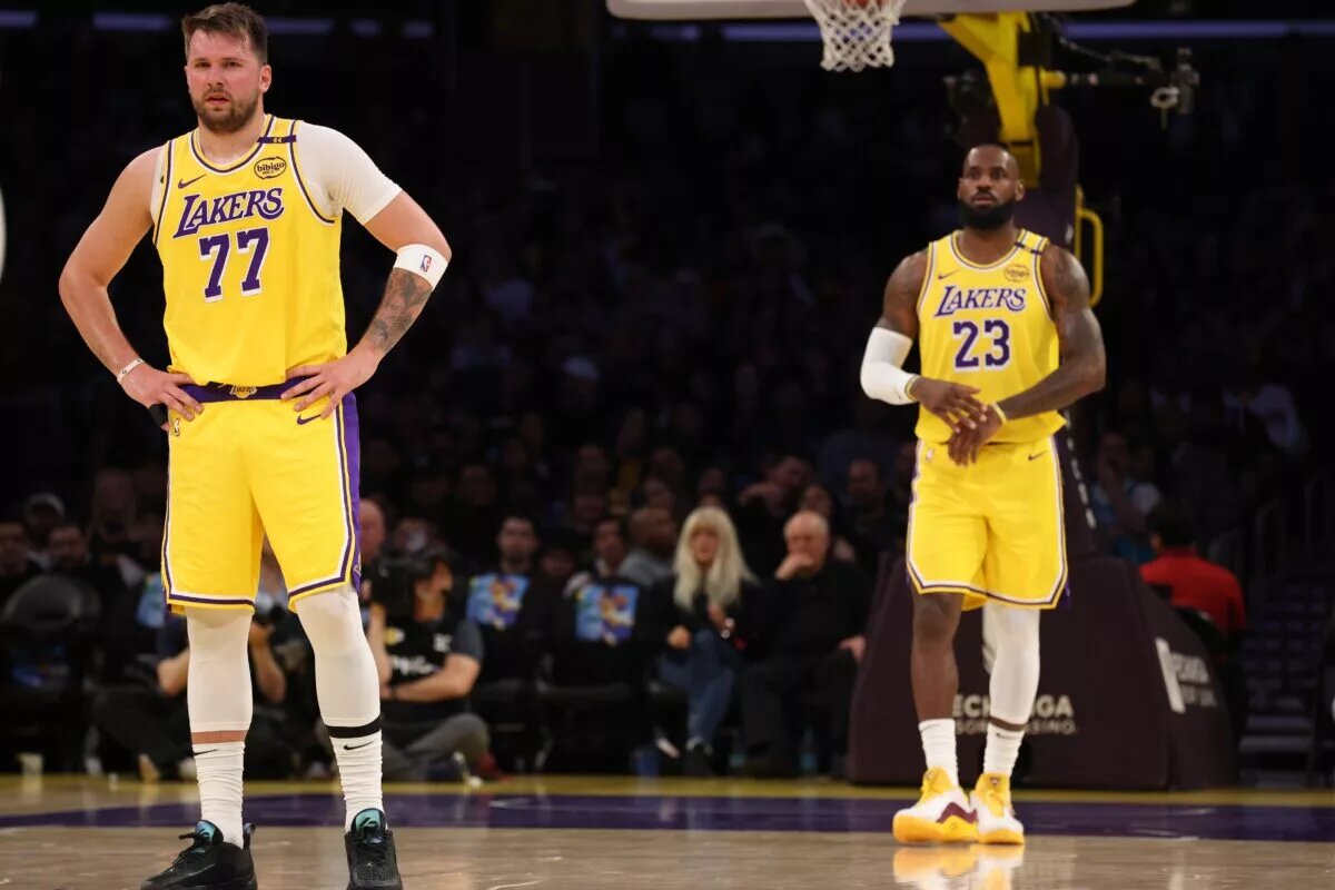 Los Angeles Lakers forward LeBron James (23) and guard Luka Doncic (77) during the first quarter against the Charlotte Hornets