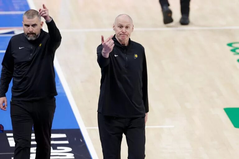 Indiana Pacers head coach Rick Carlisle (center) motions to the team bench