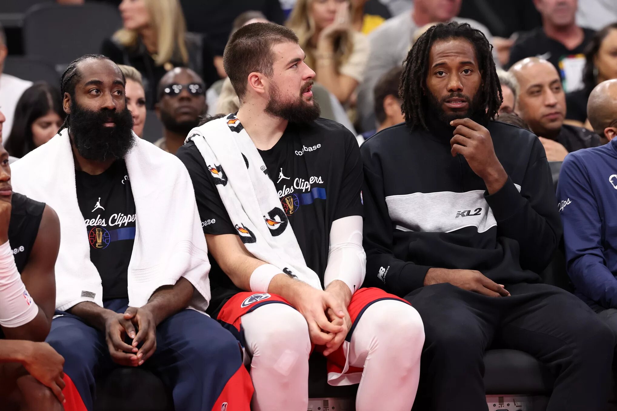 Nov 22, 2024; Inglewood, California, USA; Los Angeles Clippers guard James Harden (1, left) and center Ivica Zubac (40, center) and Kawhi Leonard (right) watch a game from the bench during the second half against the Sacramento Kings at Intuit Dome. Mandatory Credit: Kiyoshi Mio-Imagn Images