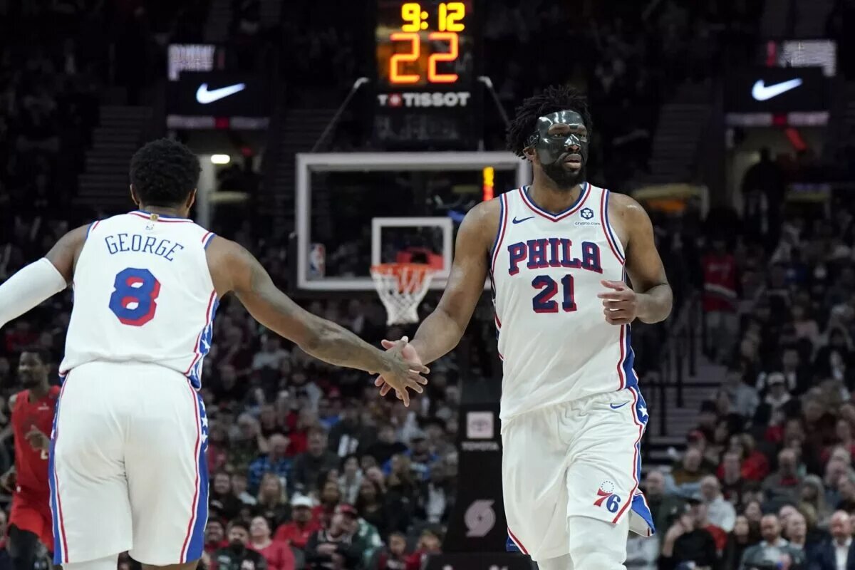 Philadelphia 76ers center Joel Embiid (21) and forward Paul George