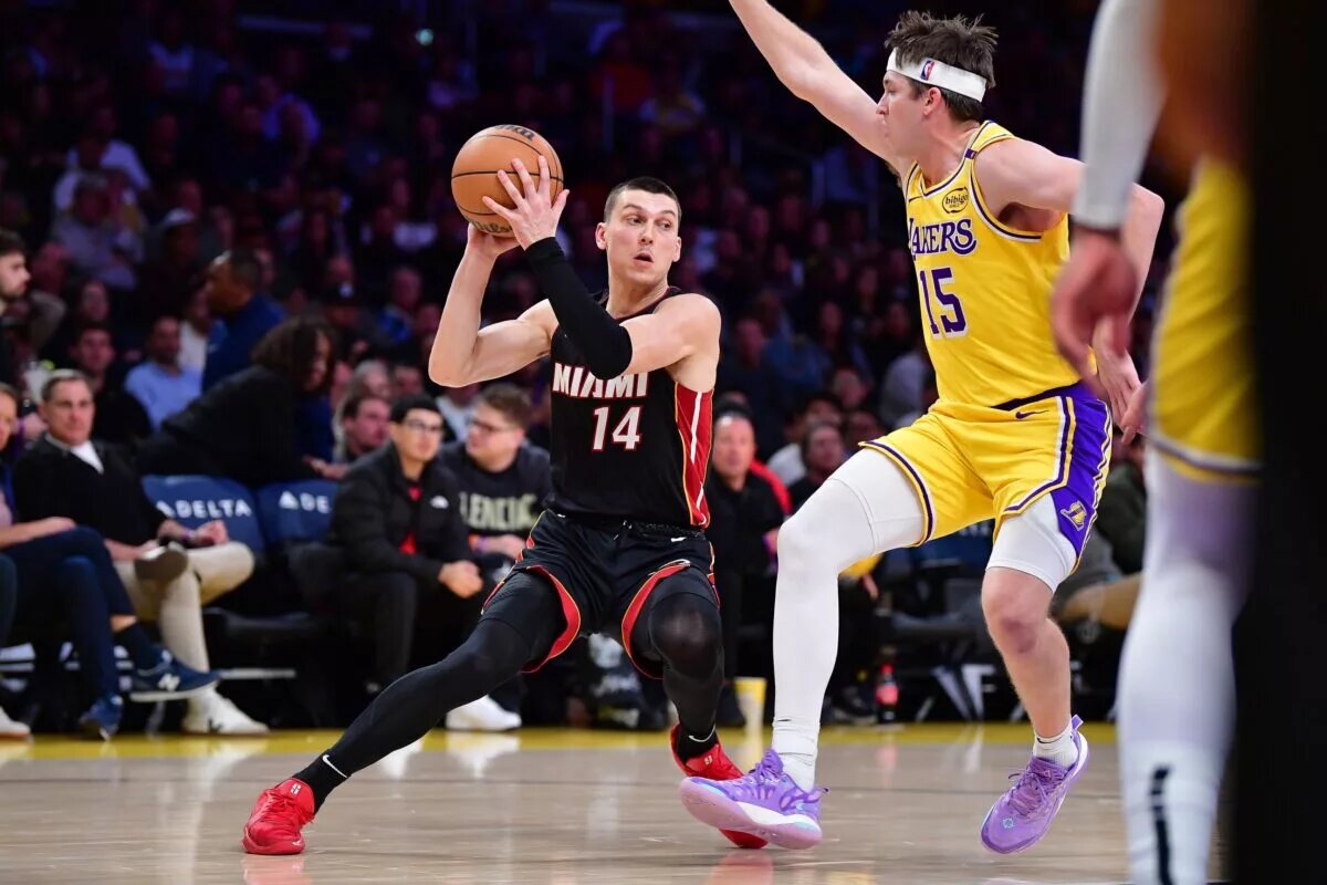 Miami Heat guard Tyler Herro (14) crosses over Los Angeles Lakers guard Austin Reaves (15)