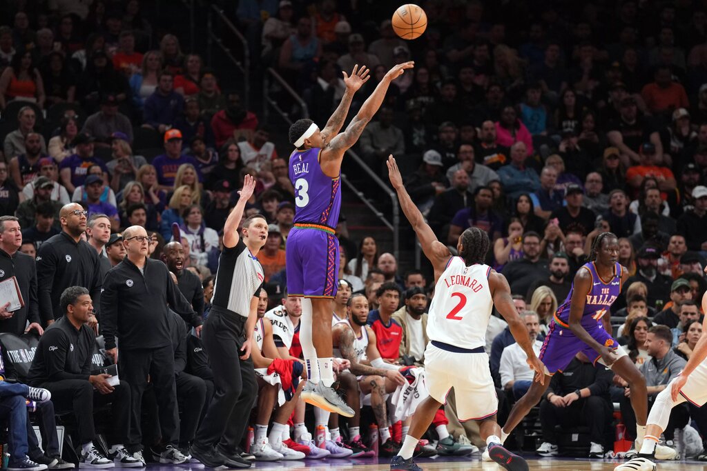 Mar 4, 2025; Phoenix, Arizona, USA; Phoenix Suns guard Bradley Beal (3) shoots against LA Clippers forward Kawhi Leonard (2) during the first half at PHX Center. Mandatory Credit: Joe Camporeale-Imagn Images