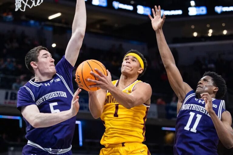 Mar 12, 2025; Indianapolis, IN, USA; Minnesota Golden Gophers guard Isaac Asuma (1) shoots the ball while Northwestern Wildcats center Keenan Fitzmorris (5) and guard Jordan Clayton (11) defend in the second half at Gainbridge Fieldhouse. Mandatory Credit: Trevor Ruszkowski-Imagn Images
