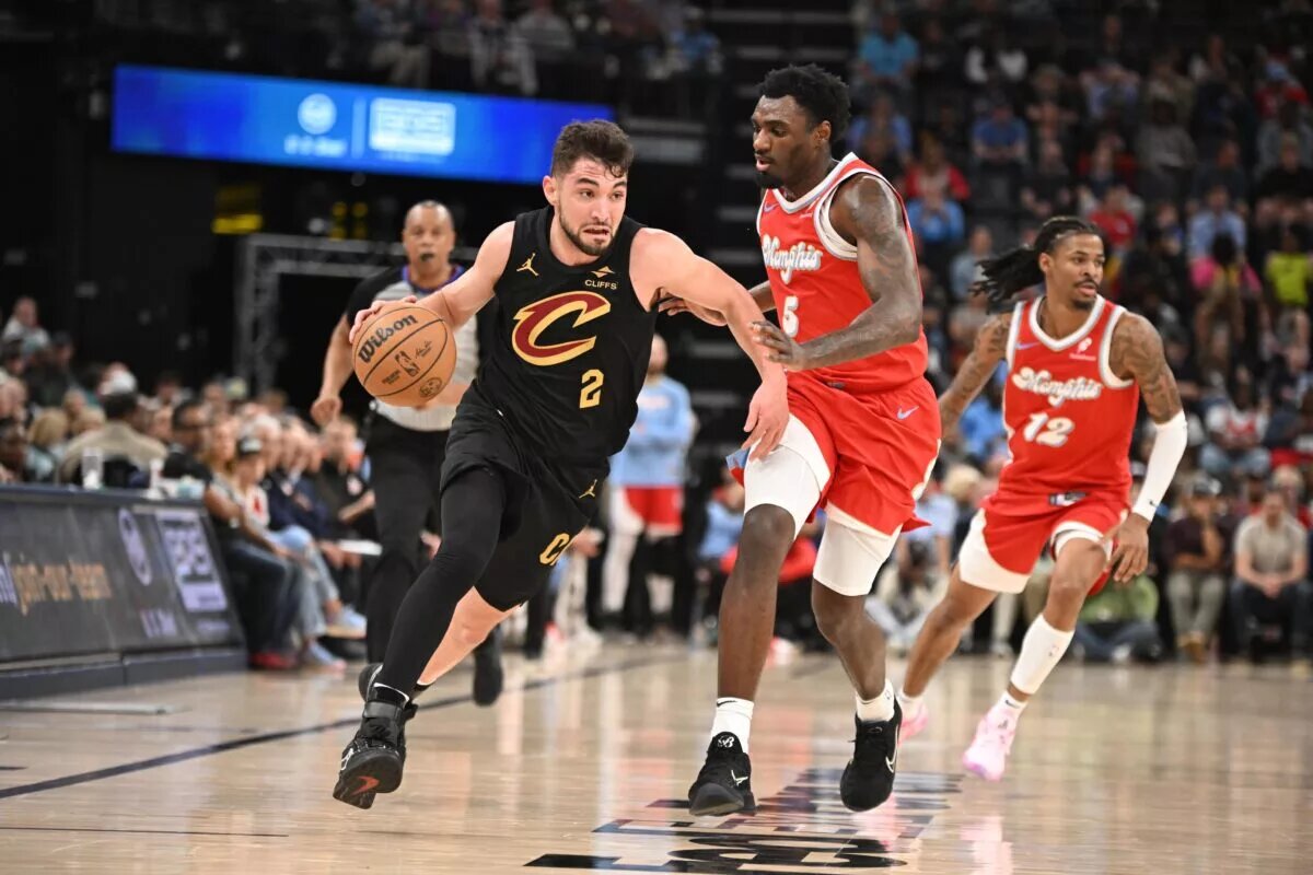 Mar 14, 2025; Memphis, Tennessee, USA; Cleveland Cavaliers shooting guard Ty Jerome (2) drives past defender Memphis Grizzlies guard Vince Williams Jr. (5) in the 4th quarter of the Cleveland Cavaliers vs. Memphis Grizzlies game at FedExForum. Mandatory Credit: Matthew Smith-Imagn Images