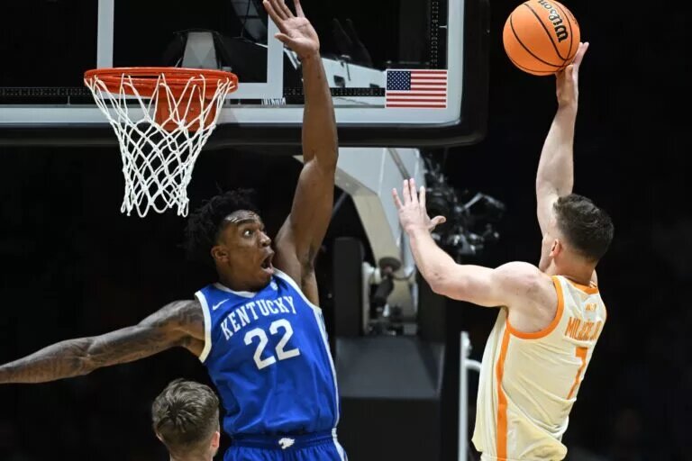 Mar 28, 2025; Indianapolis, IN, USA; Kentucky Wildcats center Amari Williams (22) attempts to block the shot of Tennessee Volunteers forward Igor Milicic Jr. (7) in the second half during a Midwest Regional semifinal of the 2025 NCAA tournament at Lucas Oil Stadium. Mandatory Credit: Robert Goddin-Imagn Images
