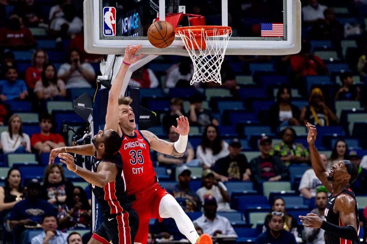 Apr 11, 2025; New Orleans, Louisiana, USA; Miami Heat guard Alec Burks (18) blocks the dunk attempt of New Orleans Pelicans center Kylor Kelley (35) during the first half at Smoothie King Center. Mandatory Credit: Stephen Lew-Imagn Images