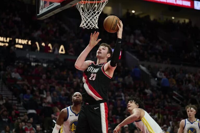 Apr 11, 2025; Portland, Oregon, USA; Portland Trail Blazers center Donovan Clingan (23) scores a basket during the second half against the Golden State Warriors at Moda Center. Mandatory Credit: Troy Wayrynen-Imagn Images